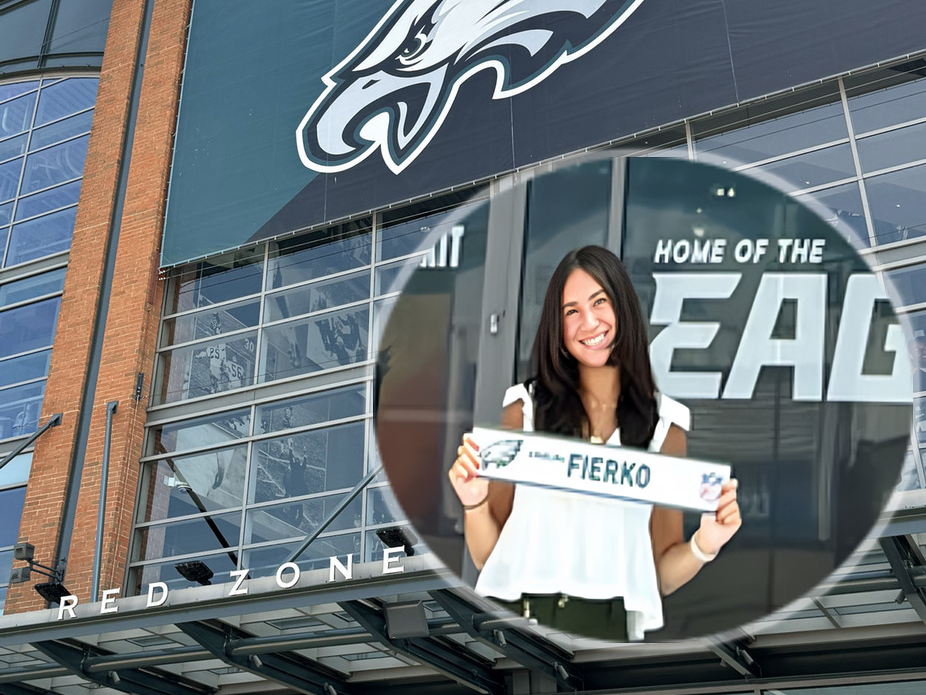 Philadelphia Eagles intern and CofC student Angelina Fierko holds up her name plate outside Lincoln Financial Field