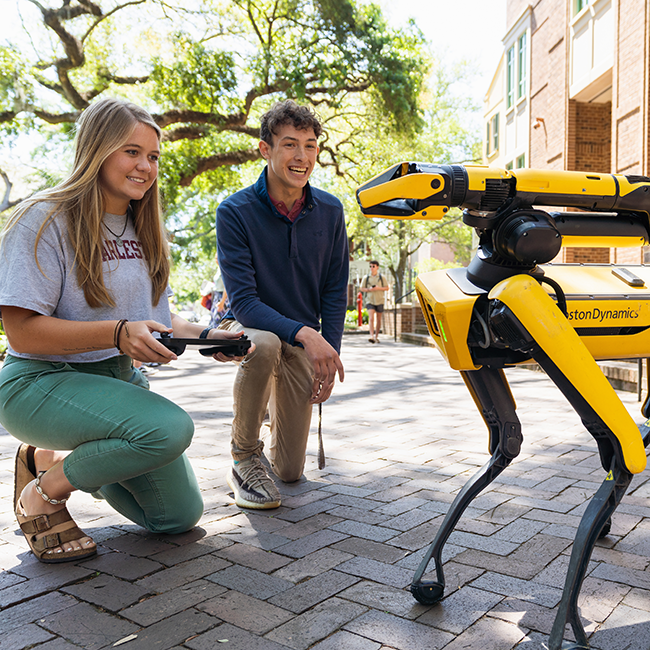Two students controlling a robot from BostonDynamics