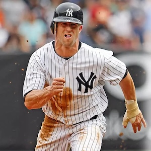 New York Yankees player, Brett Gardner, in a pinstriped uniform running during a game, with dirt stains on the jersey.
