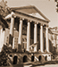 Historic Randolph Hall with large columns and a grand facade, captured in sepia tone.