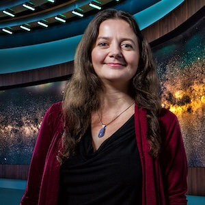 College of Charleston's alumni, Tabetha Boyajian standing inside of a theatre.