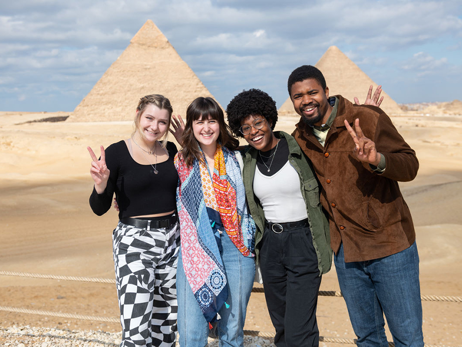 College of Charleston students standing in front of pyramids in Egypt. 