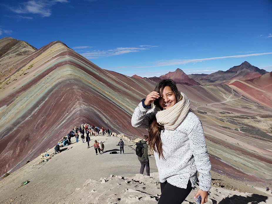 College of Charleston student in in Peru with the Rainbow Mountains in the background. 