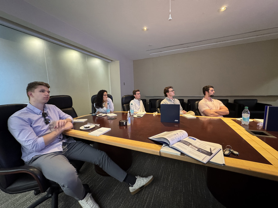 People sitting in a board room look at a presentation