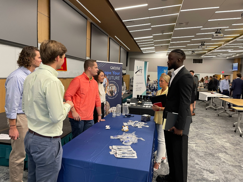 Students speaking at Meet the Firms event table