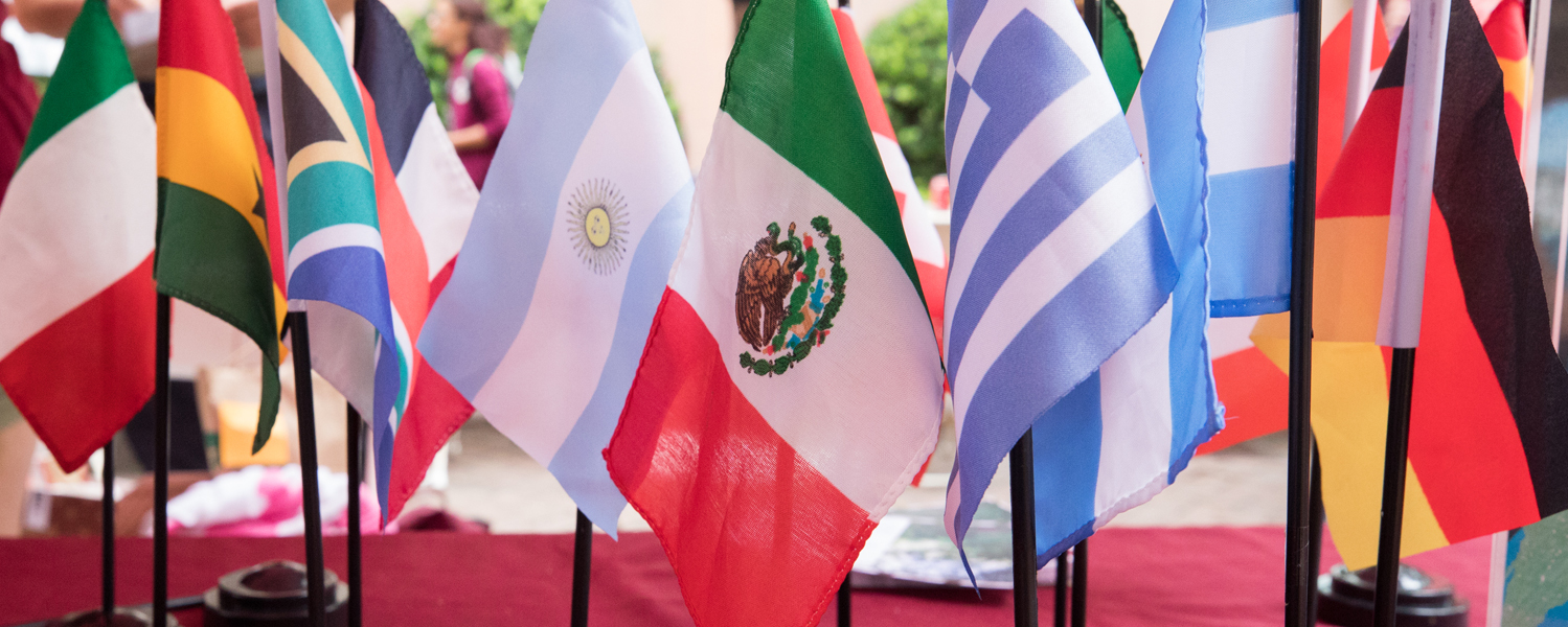 Small international flags including Germany, Argentina, Mexico and Italy, on a table top
