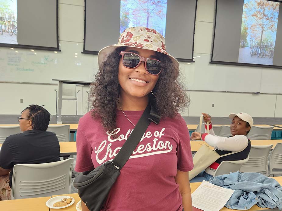 Student wearing College of Charleston hat and t-shirt. 