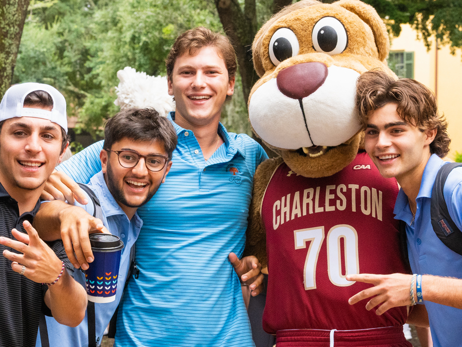 College of Charleston mascot Clyde the Cougar poses with a group of male student fans.