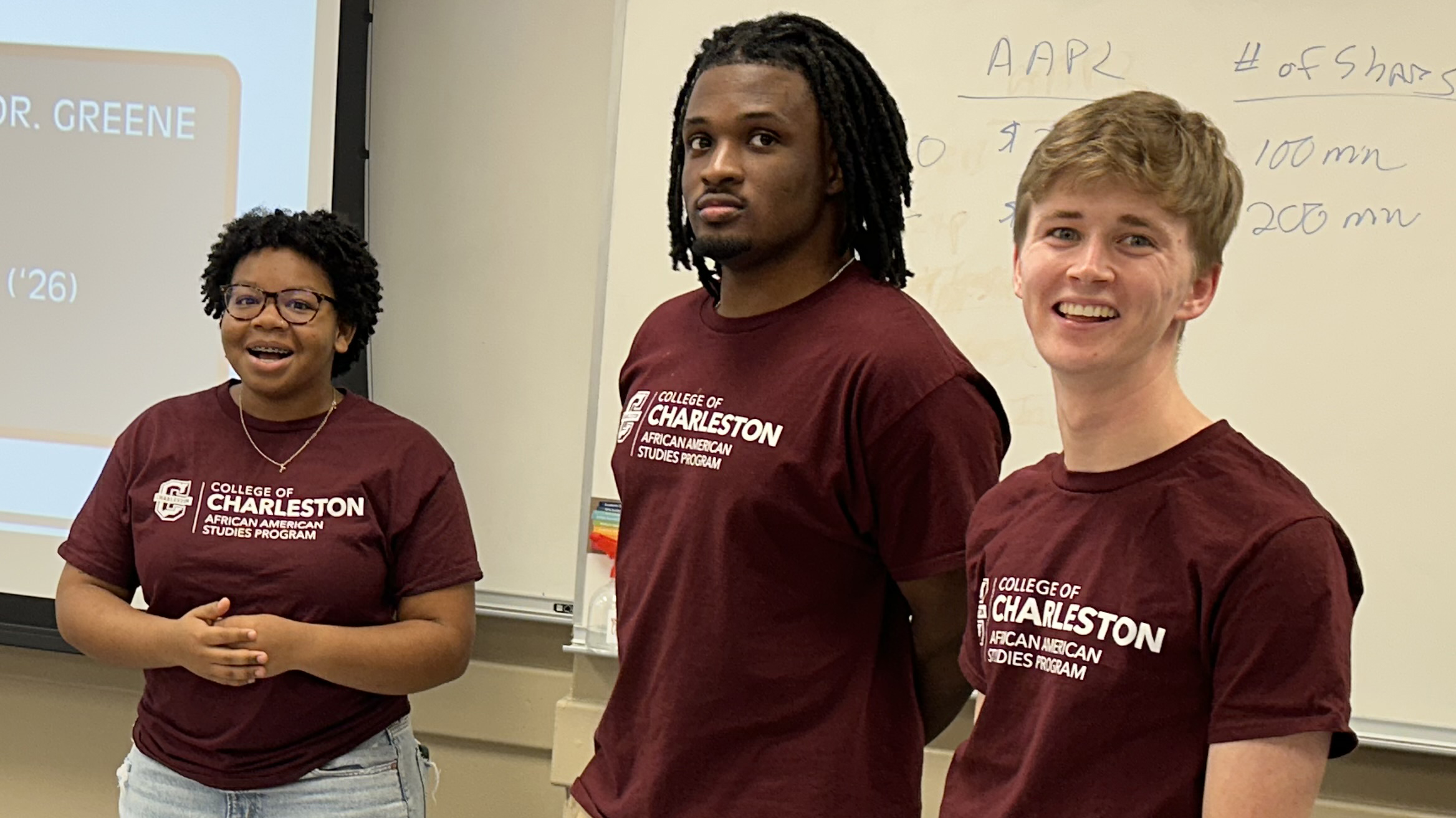 Black female, black male, and white male in a classroom.