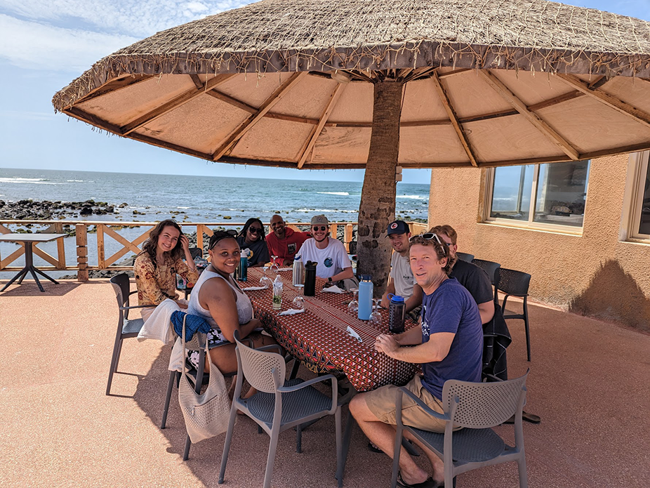 Students eating breakfast with a view of the beach.