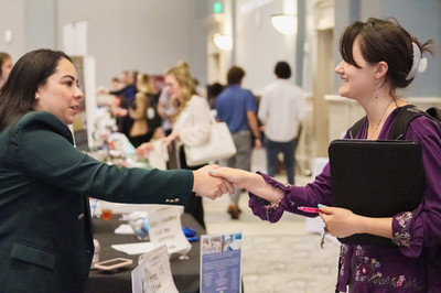Employer shaking hands with student at a career fair