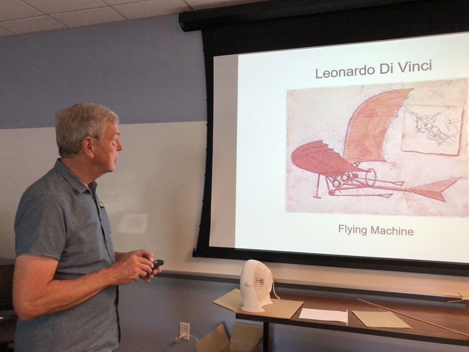 Retired US Air Force Officer John Barth shows the drawing of Leonardo Di Vinci's Flying Machine on the screen during his presentation on the "Evolution of Aerial Warfare."