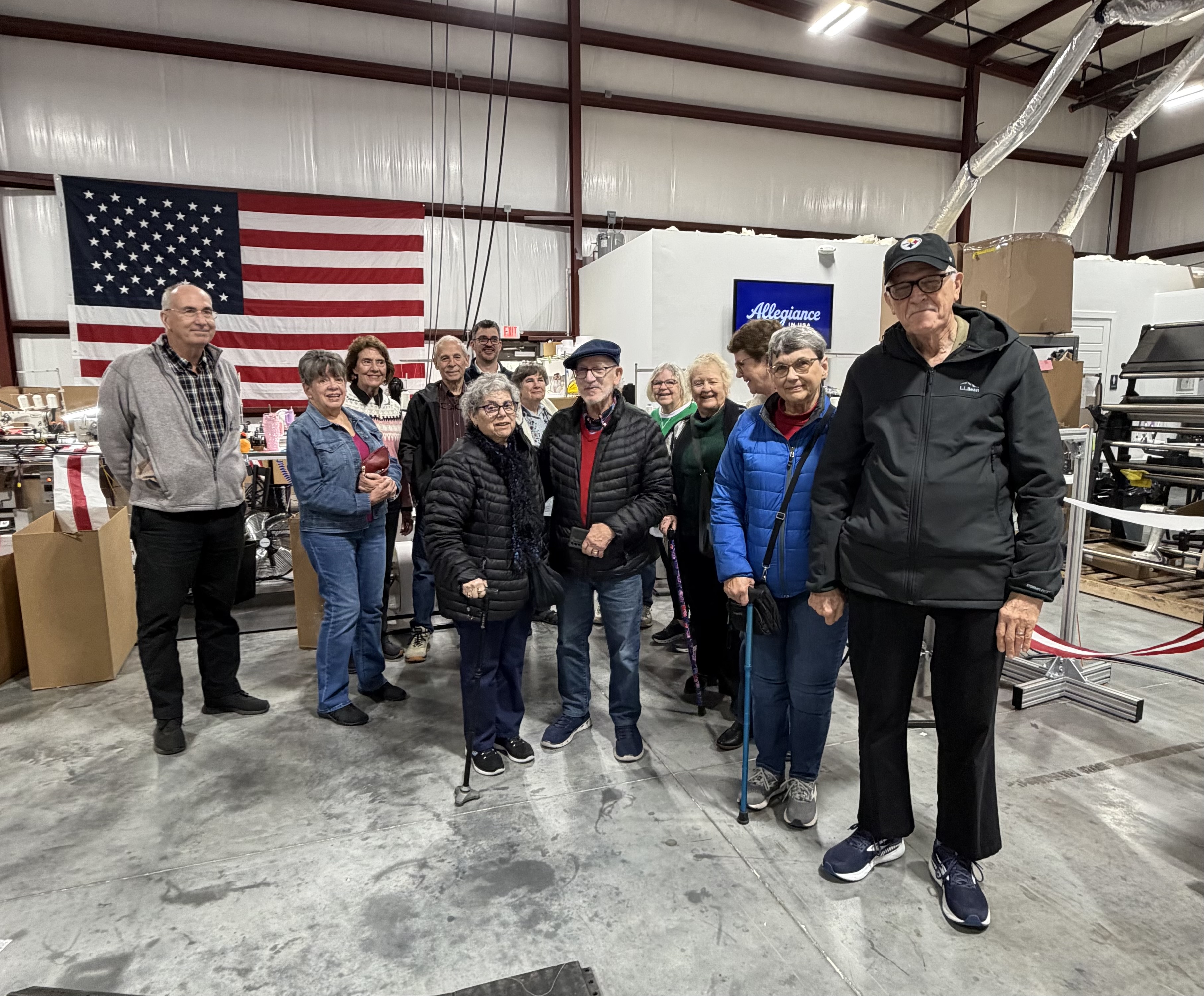Group touring the factory floor of Alligiance Flag co.