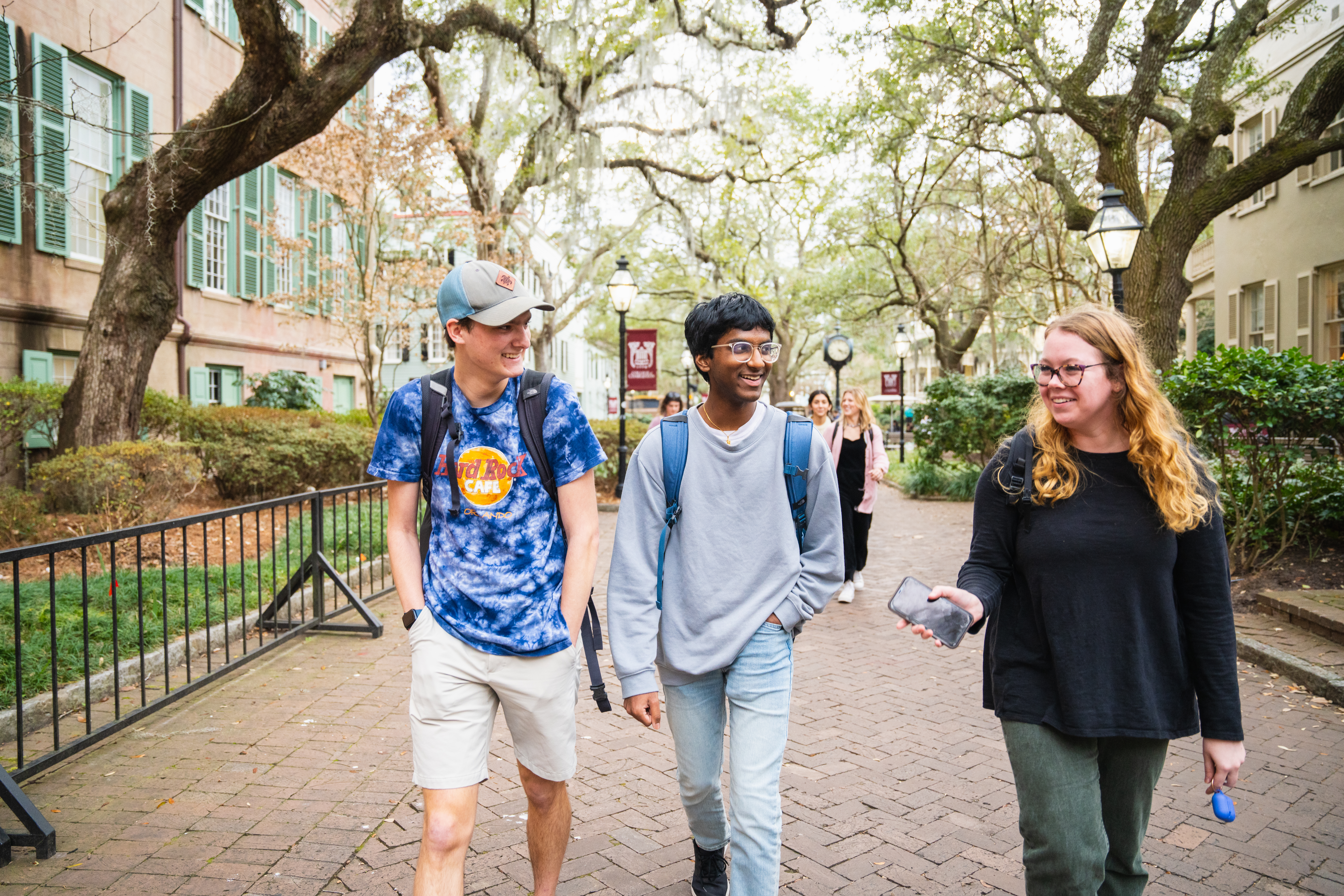 three students walking together on college campus