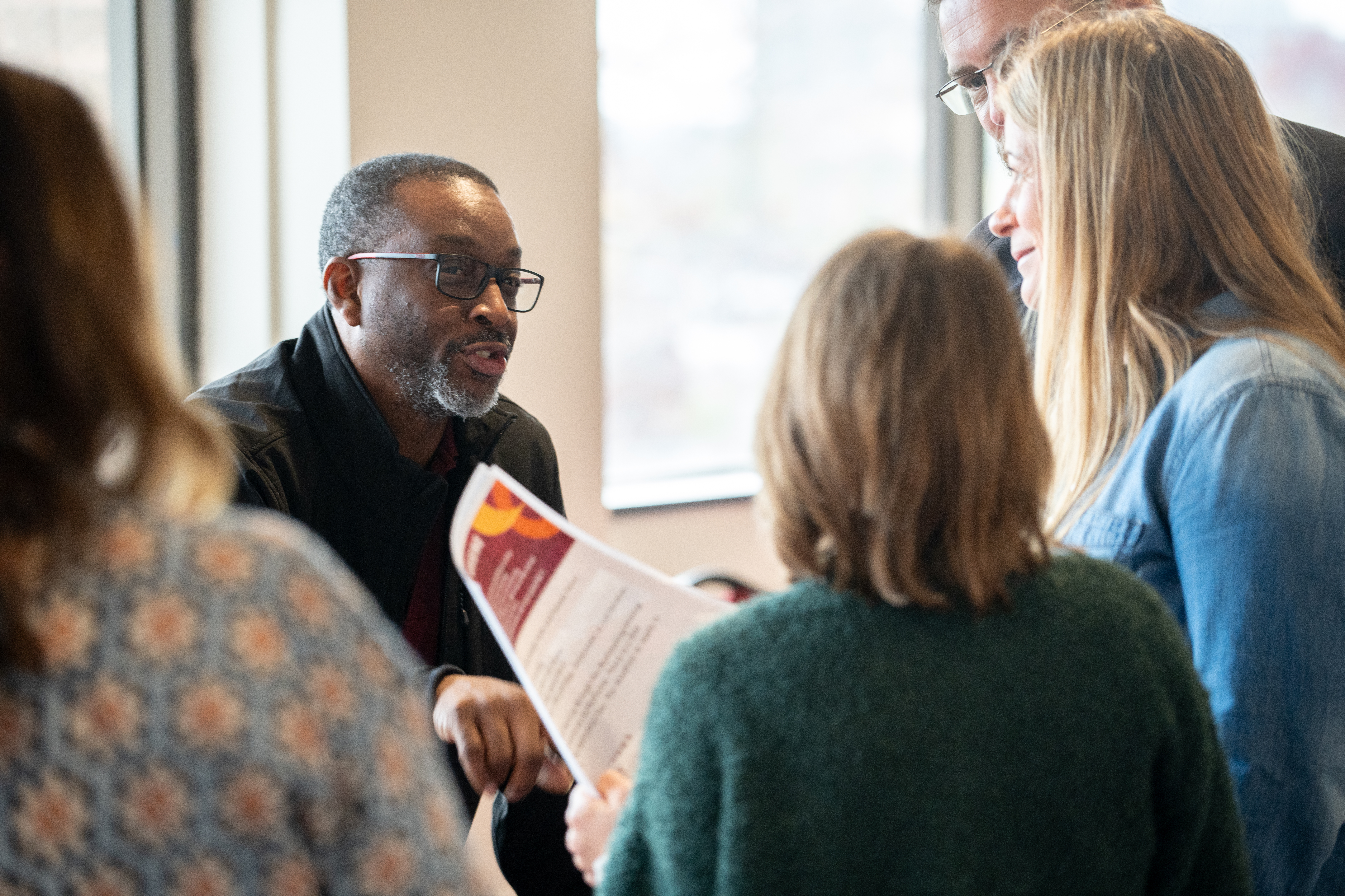 man speaking with people