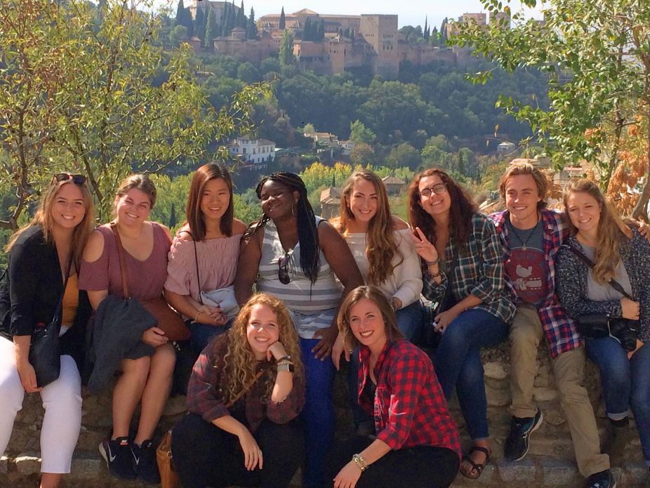 Students smiling with European skyline in the background