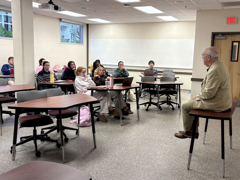 Students listening to guest speaker in capstone class