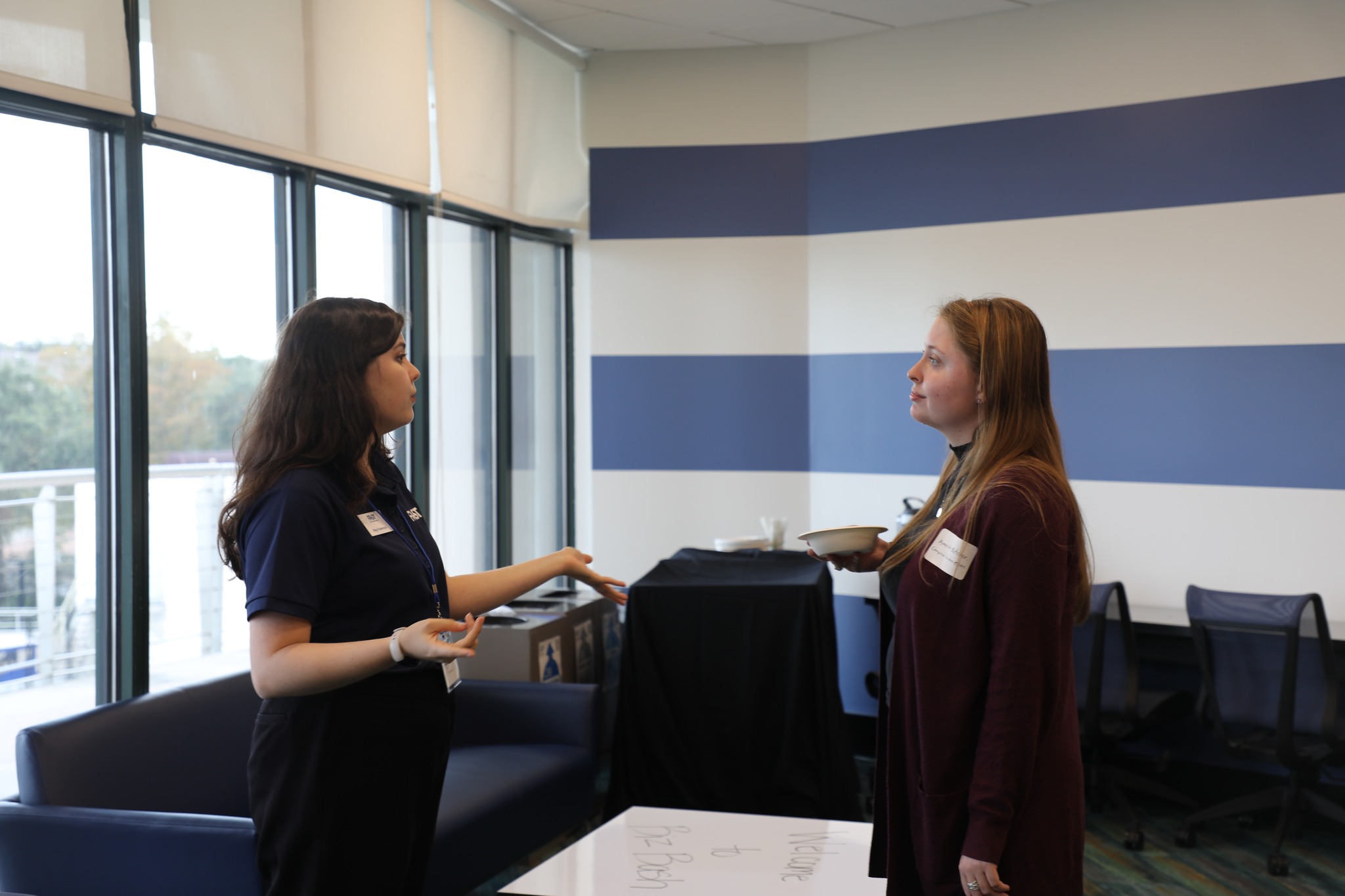 A female student meets with a female company representative at BizBash