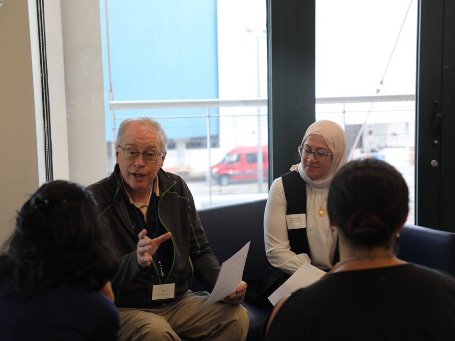 A group of three students chat with a potential employer at BizBash