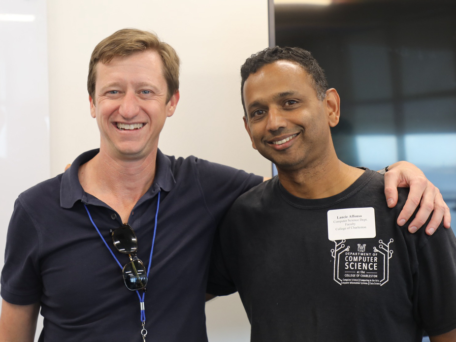 A visiting company representative and a computer science faculty member smile for the camera at BizBash