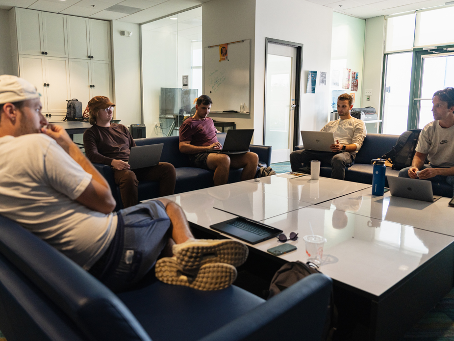Students collaborate around a table at the Computer Science Innovation Center.