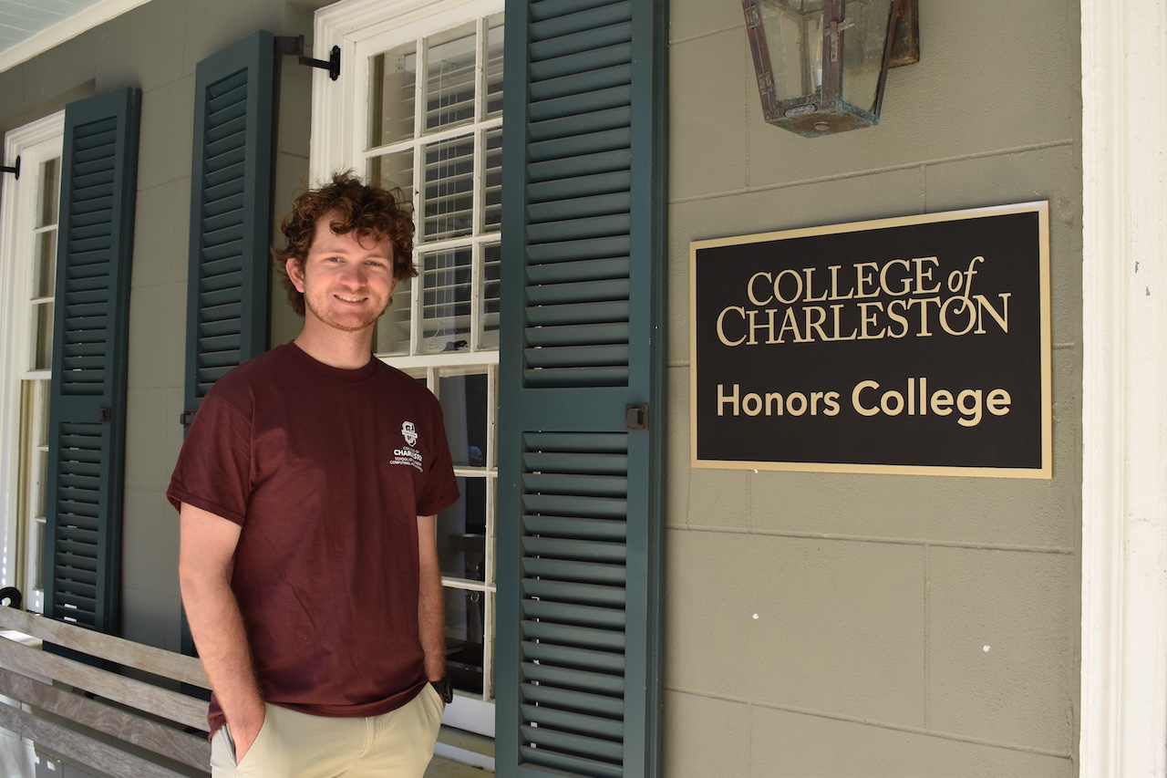 Bo Dwyer poses in front of the Honors College. 