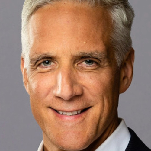 Closeup of a man with white hair smiling