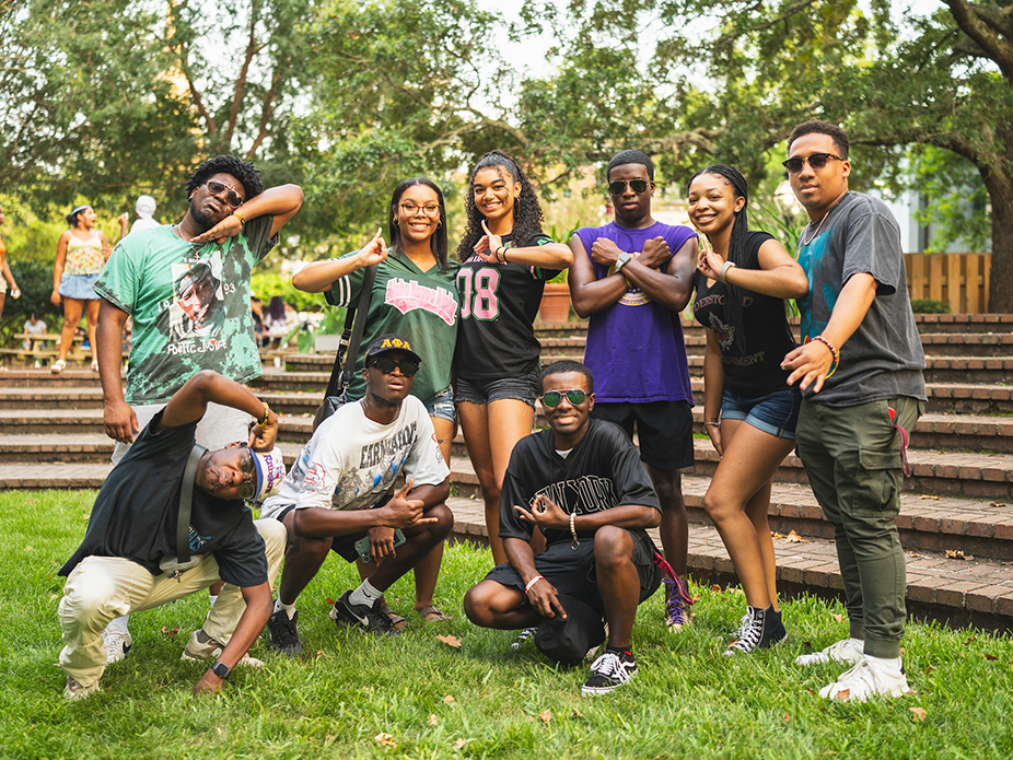 Greek life members posing with each other and wearing Greek Life shirts. 