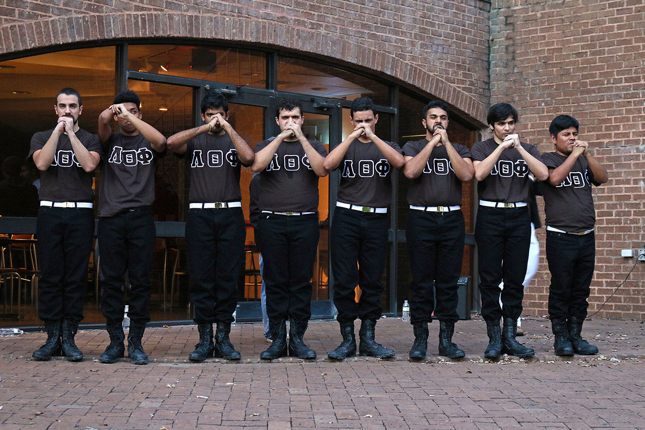 Lambda Theta Phi Latin Fraternity Inc. Standing together at attention. 