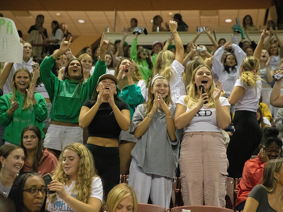 Pep supper Greek life cheering for another Greek life performance. 