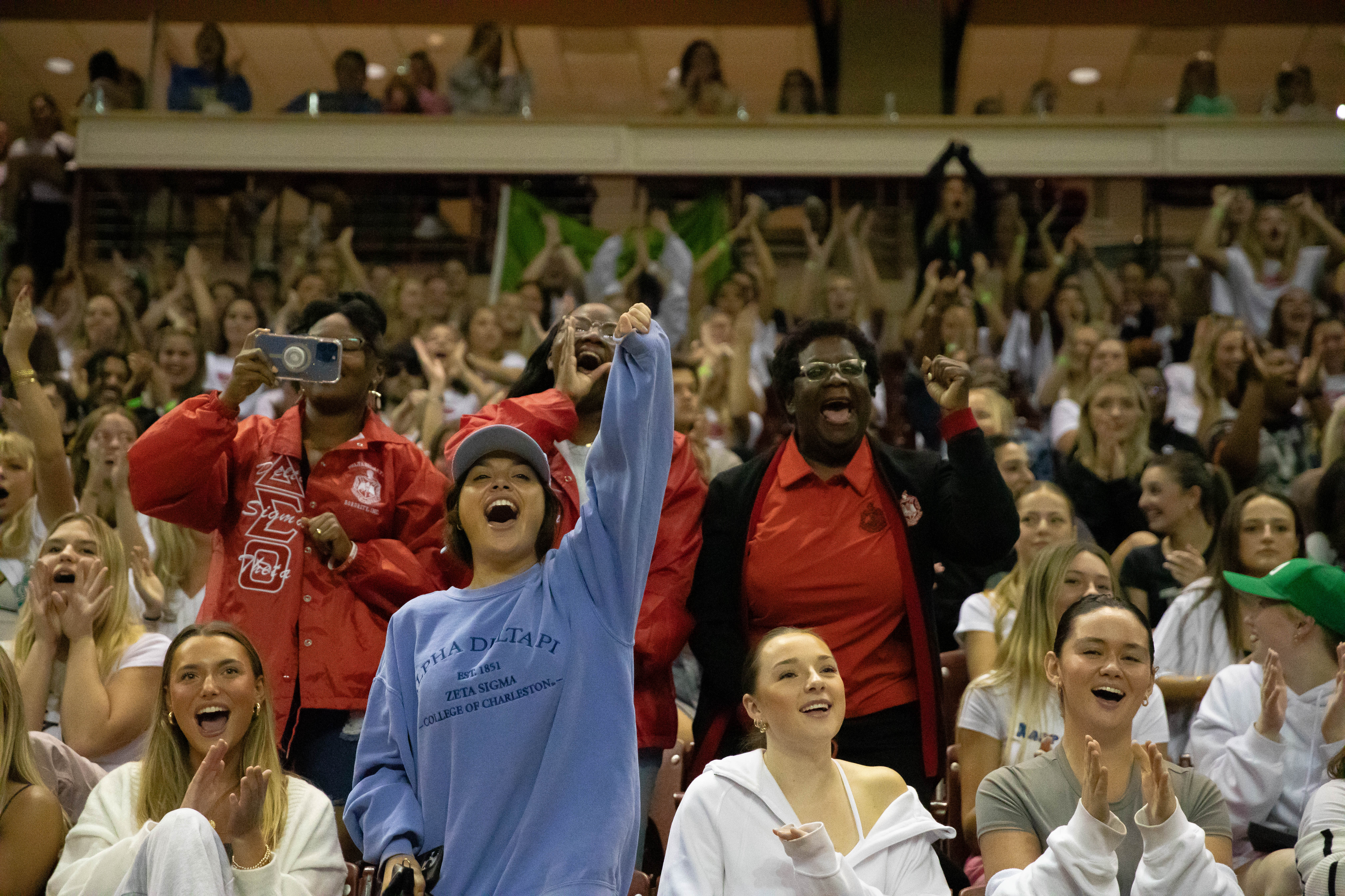 Greek Life Members cheering on a performance by another Greek Life group at pep supper.