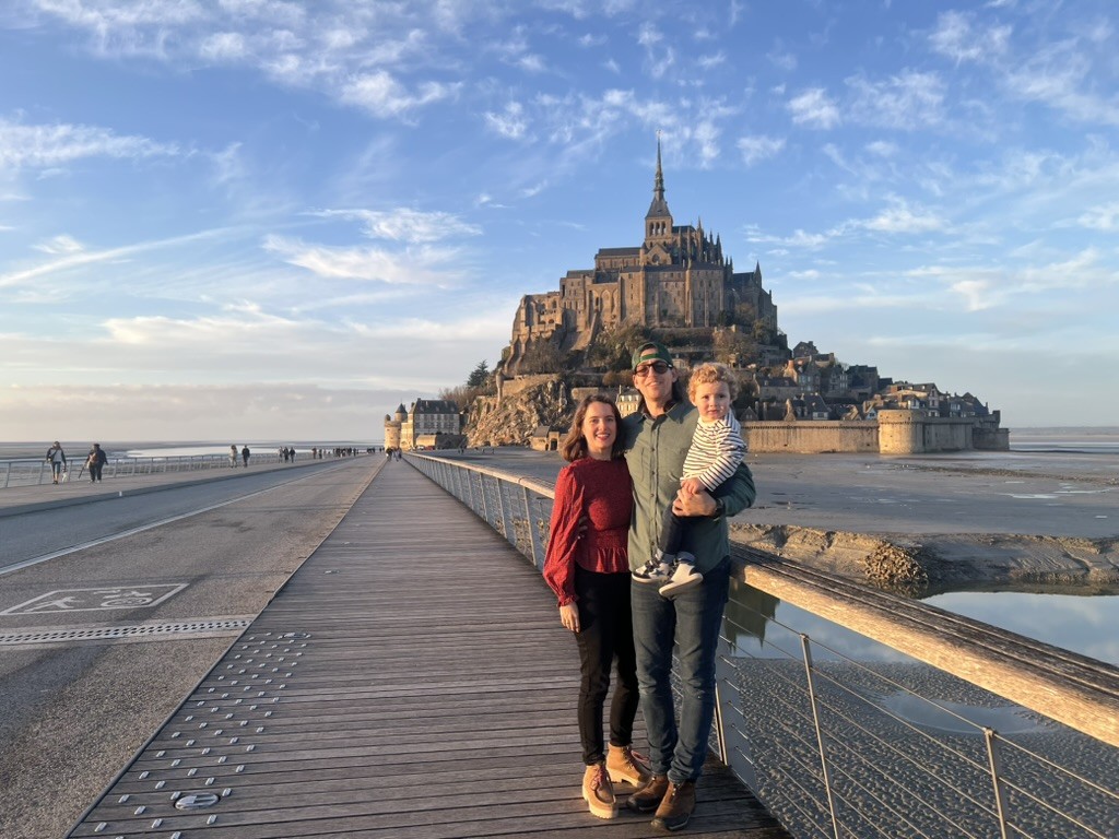 College of Charleston alumna, Eliza Morrison, and her family in front of  Mont Saint-Michel, a commune in France