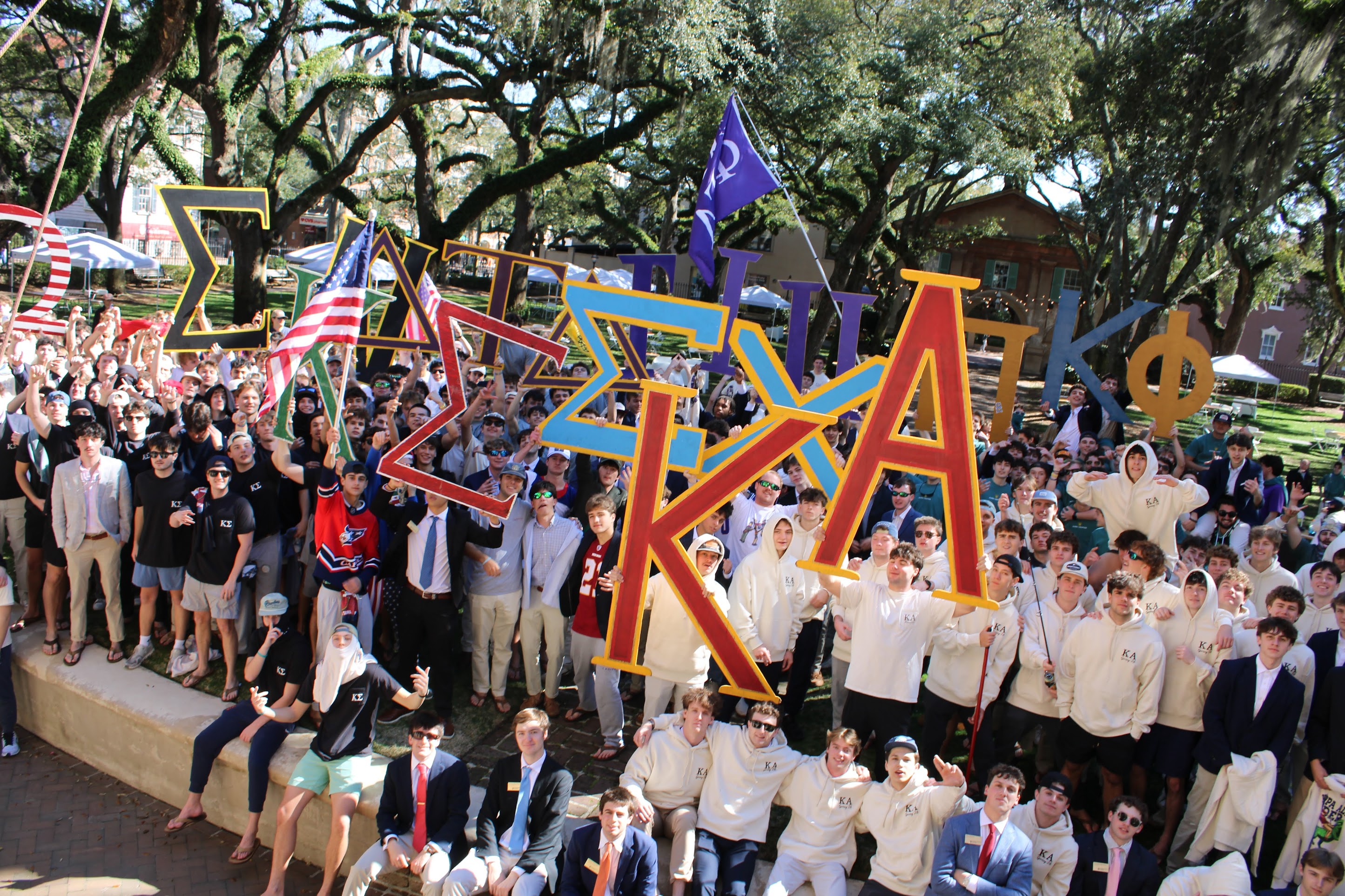 IFC groups standing together and celebrating while showcasing their Greek Letters. 