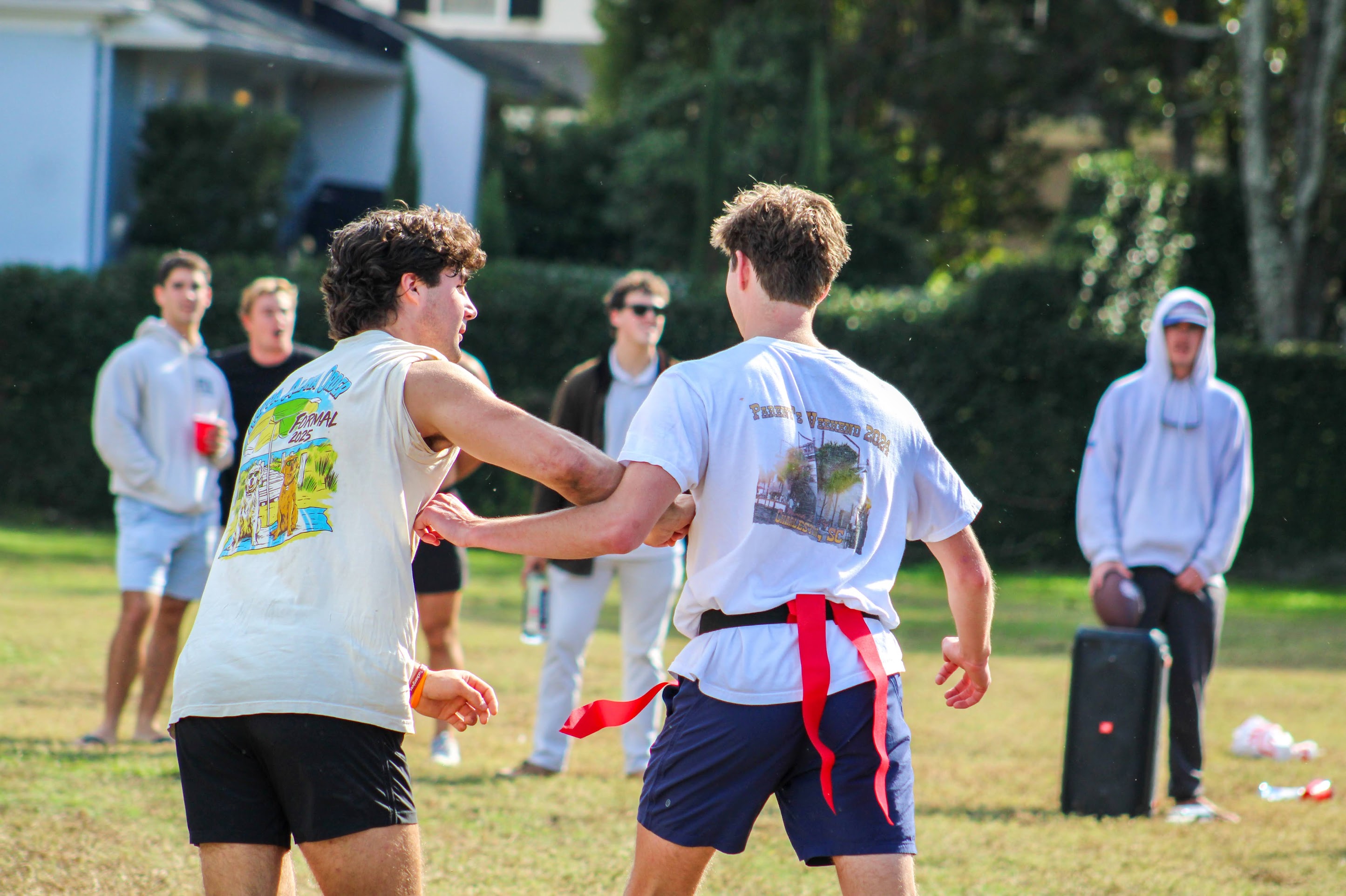 IFC men playing flag football as a group. 