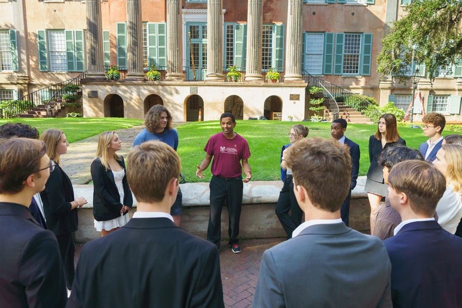 A class discusses networking outside in the Cistern Yard.