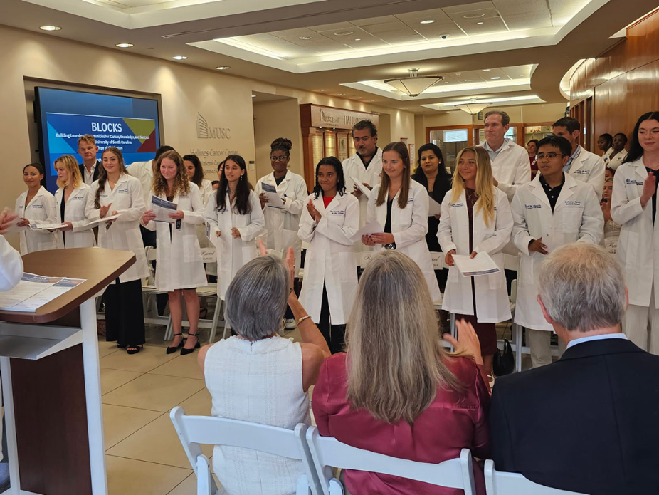 Ten students in the MUSC B.L.O.C.K.S. program clap during a ceremony inaugurating them into the program.