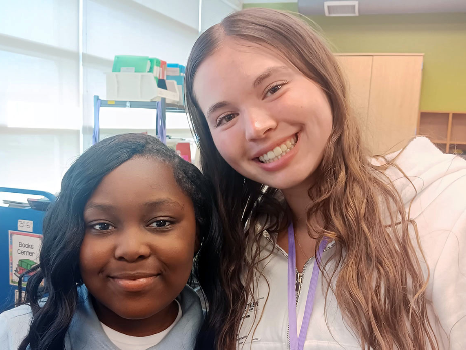 Honors College student Claire Varnum poses with one of the elementary school students she tutors as a volunteer with nonprofit organization, Heart Math.