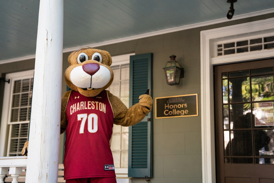 Clyde the Cougar stands outside the Honors College admissions offices