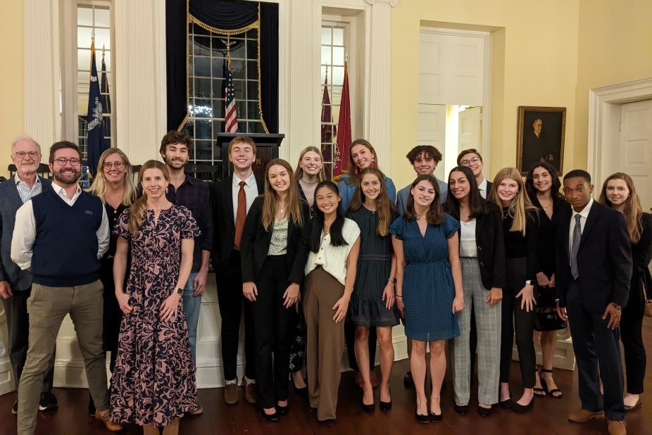 Students pose as a group during a mock etiquette reception.