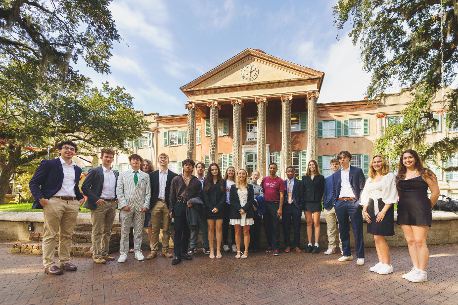 Students in the Honors E-LLC pose in business dress outside of Randolph Hall