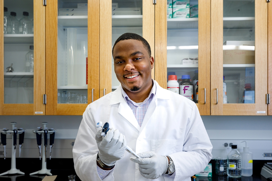 Vernon Kennedy poses in a lab coat.