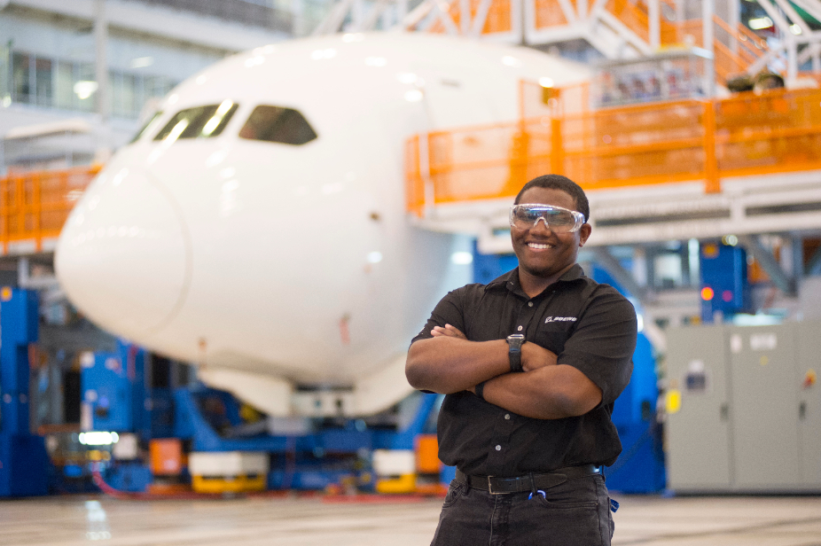 Honors College alumnus William Blanchett poses in front a an airplane at Boeing
