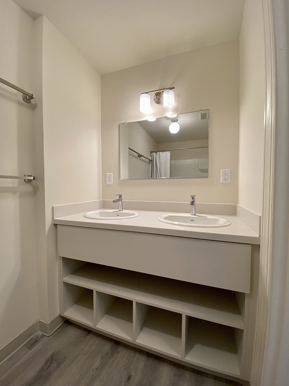 two-sink vanity and cabinet with open shelves