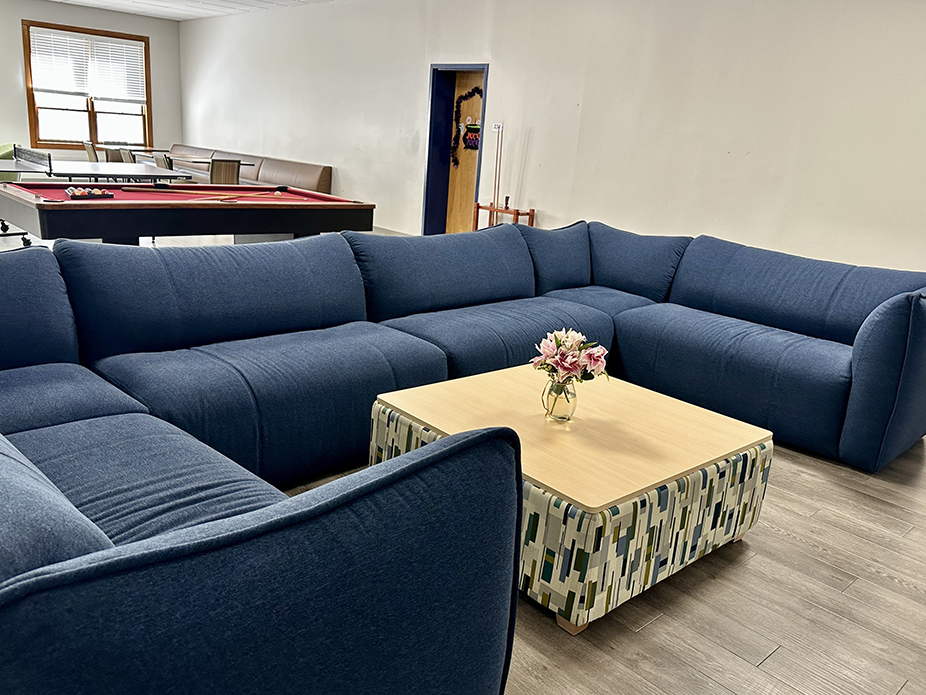 Gameroom in Craig Hall with oversized sectional sofa, pool table and table tennis