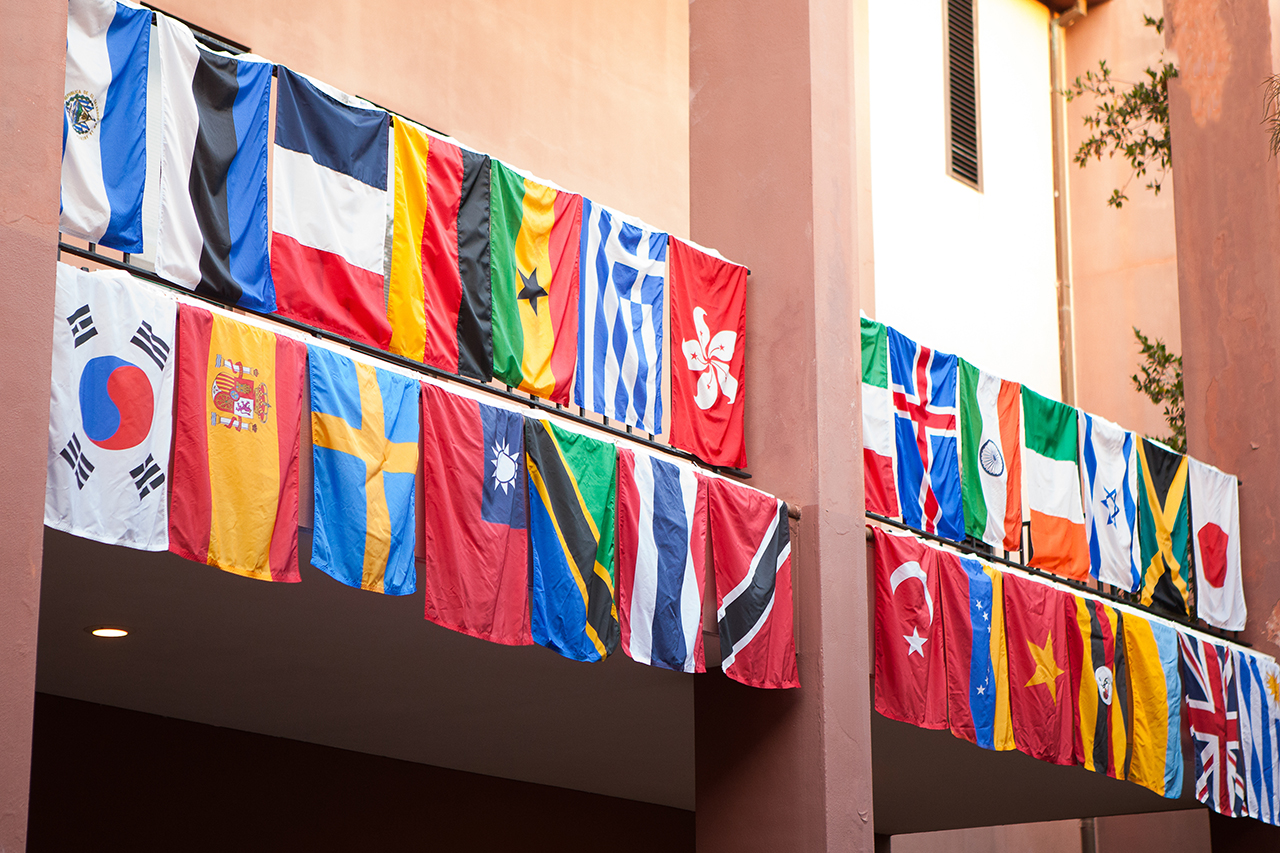 National flags hanging off the balcony of the Robert Scott Small Building