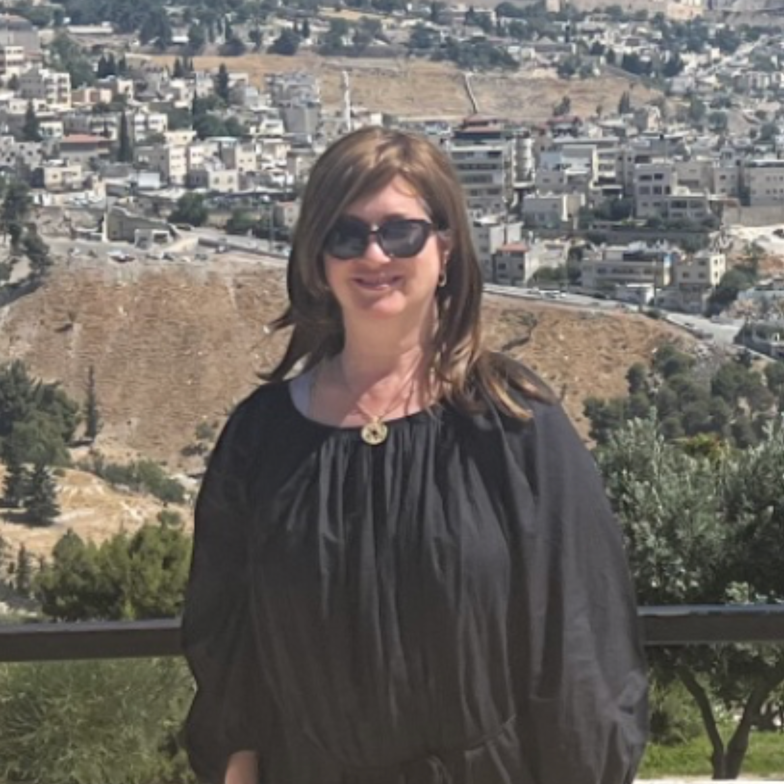 Lisa Lipschutz smiling standing in front of Jerusalem.