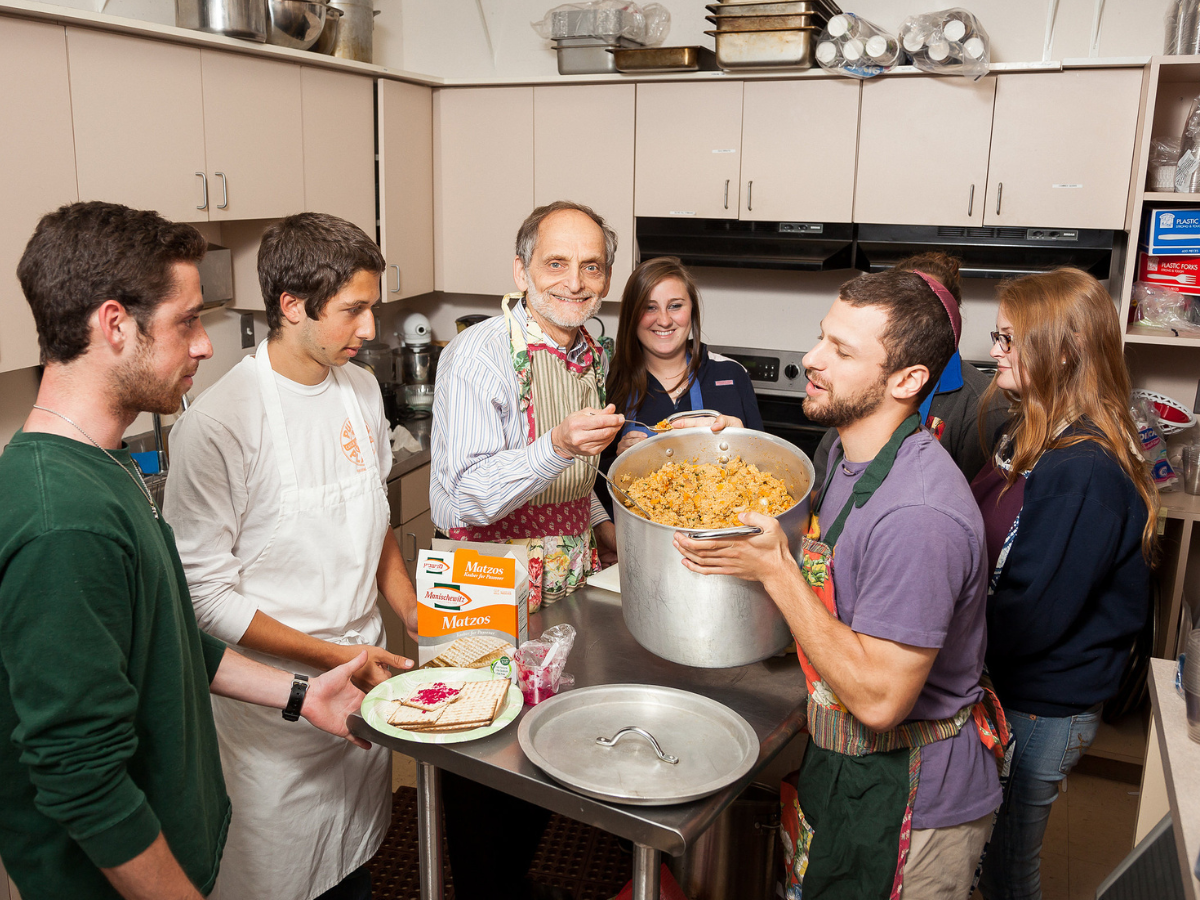 Marty Perlmutter with a group of students in the kitchen.