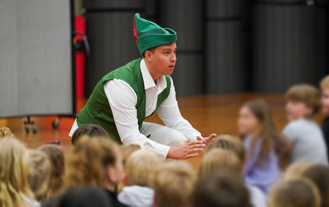 School children watch intently as a Children's Opera cast member relates the tale of Jack and the Beanstalk.