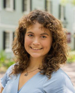 woman with brown hair in blue shirt