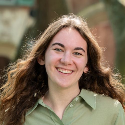 woman in green shirt with brown hair